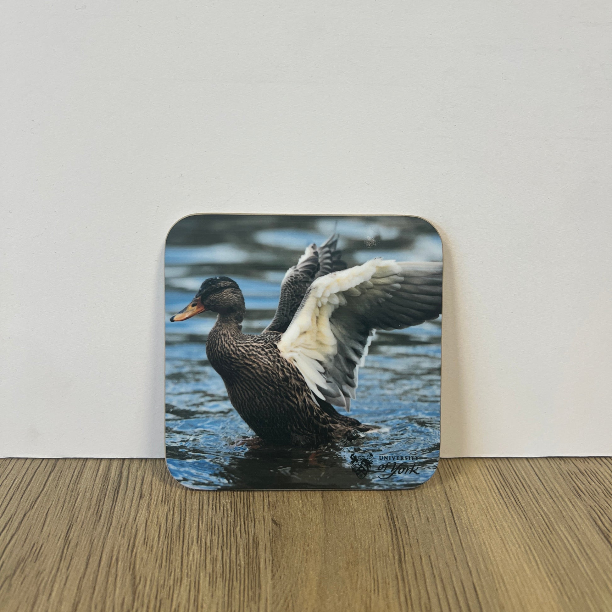 Coaster with a duck design on a wooden surface